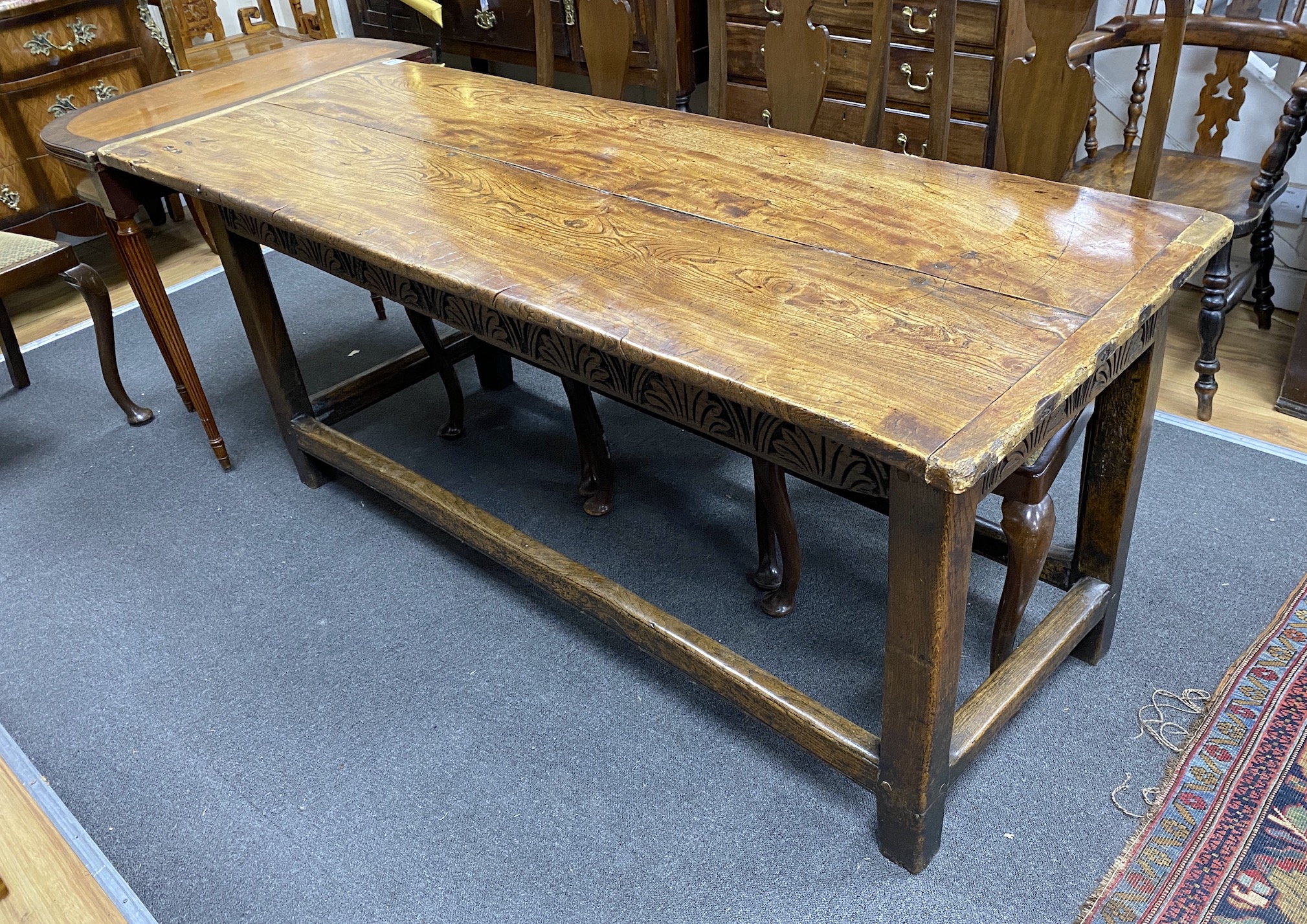 A late 17th / early 18th century elm two plank top refectory table (re-cleated), length 186cm, depth 70cm, height 76cm